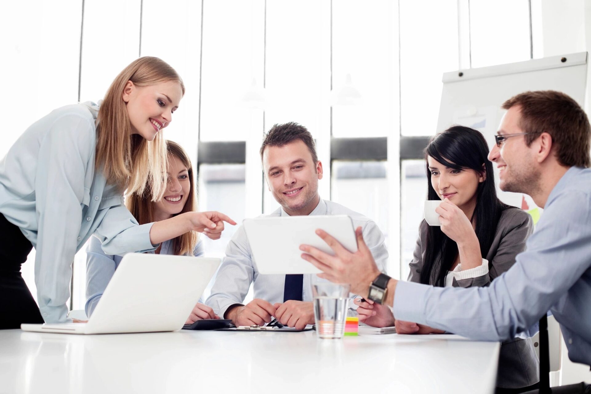 A group of employees staring at the tablet